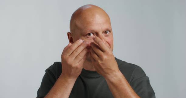 istock A man puts patches under his eyes 2197419866