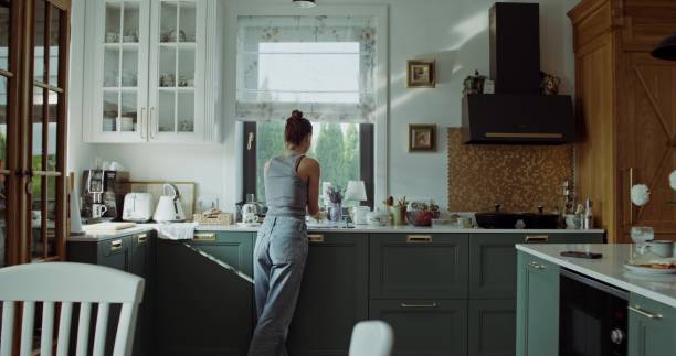 istock A woman is crying in the kitchen 2197420660
