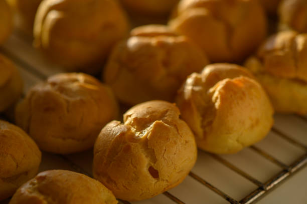 istock Golden pastry balls cooling on a wire rack after baking in a cozy kitchen 2197422215