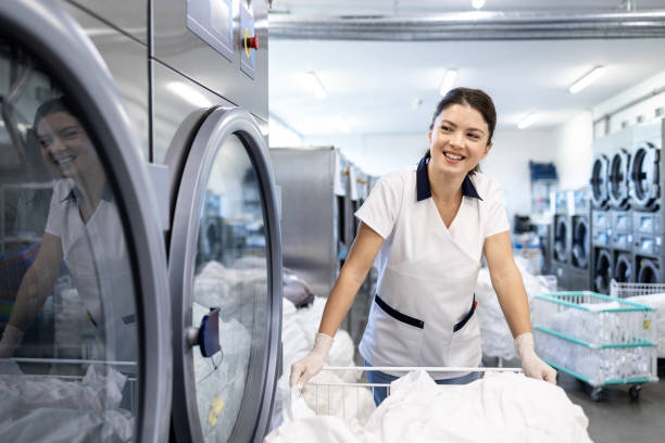 istock Professional cleaner working in dry cleaning service. 2197423372