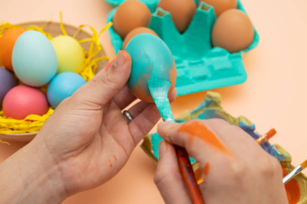 istock Male hands painting an Easter egg blue 2197423686