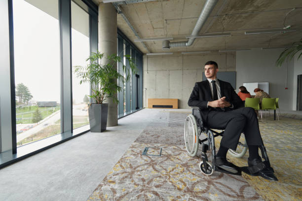 istock A director in a wheelchair sitting alone in an empty office, deeply reflecting on business strategies and decisions, contemplating the path forward with focused determination. 2197424554