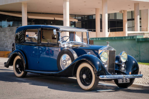 Lisbon, Portugal - Sep 29, 2024: Legendary and luxury 1937 Rolls-Royce Phantom III on sunny day in urban setting. Front grille, radiator, headlights and iconic bonnet mascot of Spirit of Ecstasy. Last car designed by Henry Royce.