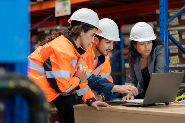 istock Multiracial warehouse staff collaborating on inventory checks with digital technology. Business strategy, leadership, and teamwork in supply chain management. Professional logistics operation ensuring accuracy and productivity in a corporate industrial 2197425747
