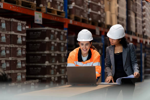 istock Diverse warehouse team analyzing stock data on a digital tablet. African manager and Middle Eastern employee collaborate on inventory management, logistics planning, and operational efficiency in a modern distribution center. 2197425749