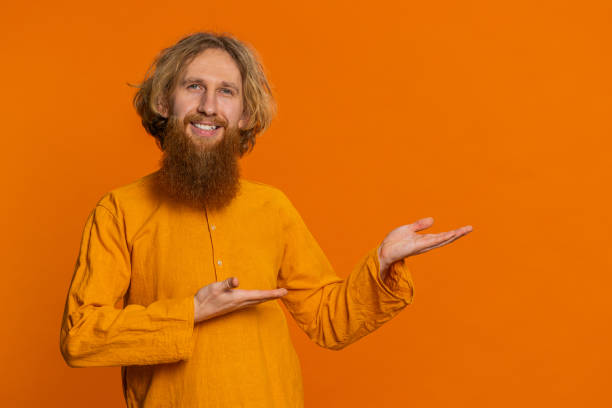 istock Young man showing thumbs up and pointing at right on blank space place for your advertisement logo 2197427921