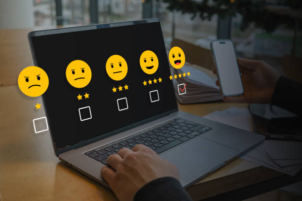 istock User providing online feedback on a laptop screen with a digital rating system of emoticons and stars. Concept of customer experience, satisfaction survey, service evaluation 2197432077