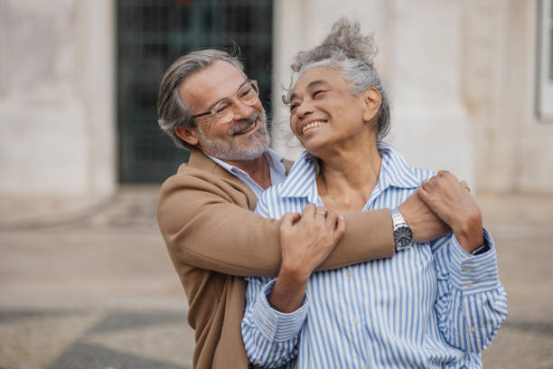 istock Joyful Embrace of Two Seniors in a Park Setting 2197433151