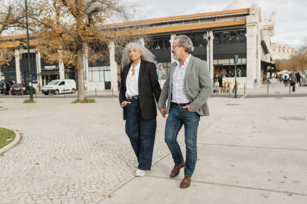 istock Couple Walking Hand in Hand Outdoors 2197433998