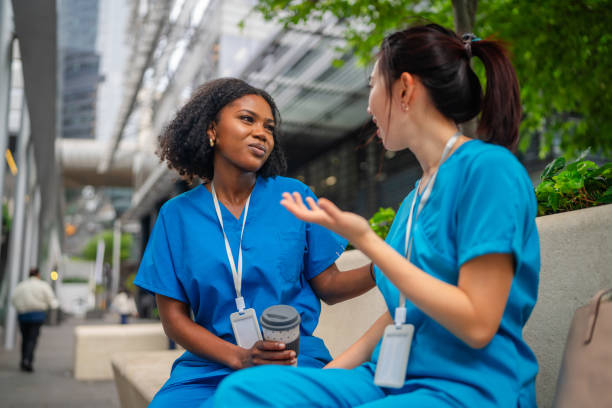 istock Women in scrubs enjoy a friendly conversation outdoors in Sydney 2197434504