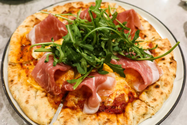 istock close up of baked Parma ham cheese pizza 2197434543