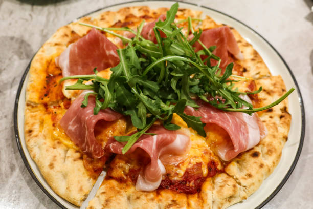 istock close up of baked Parma ham cheese pizza 2197434545