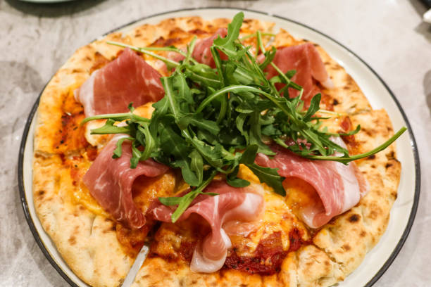 istock close up of baked Parma ham cheese pizza 2197434547