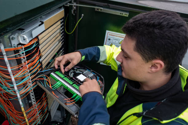fiber optic technician restores connection after cabinet failure - fibra imagens e fotografias de stock
