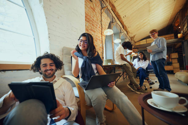 istock Modern office lifestyle. Well-lit, comfortable co-working area, young people gathering for focused and concentrated work and study 2197435062