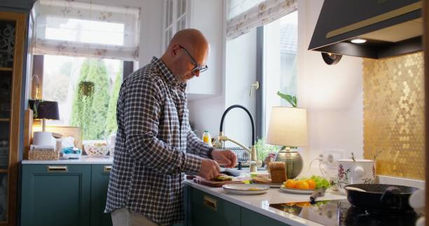 istock A man cooks at home 2197435826
