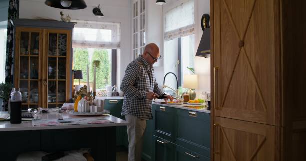 istock A man cooks at home 2197435853