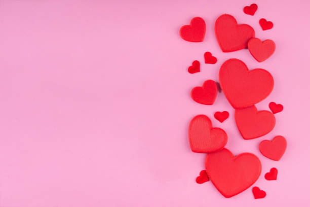 istock Valentine day pink greeting card background with red hearts 2197438727