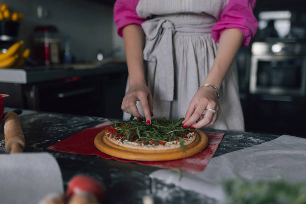 Woman making original italian pizza at home