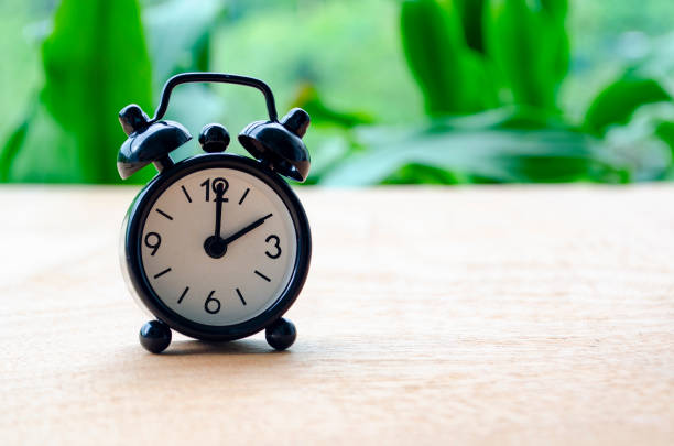 istock Table alarm clock pointing at 2pm or 2am with customizable space for text. Time management concept and copy space 2197439327