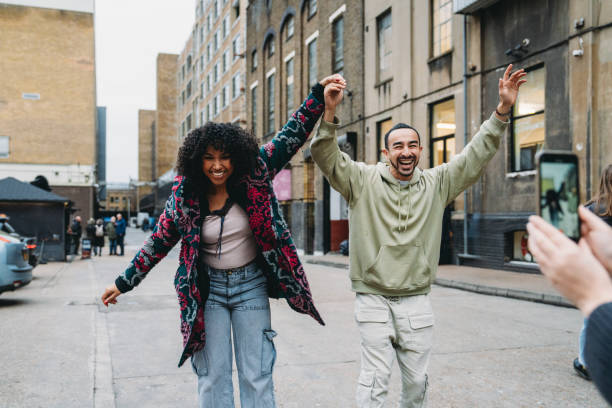 istock Young couple holding hands and posing for a photo in London 2197440077