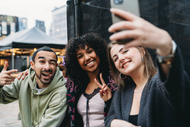 istock Three young friends taking a selfie and making funny faces 2197440132