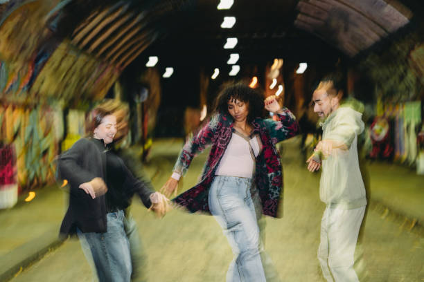 istock Young people dancing in an urban tunnel at night 2197440435