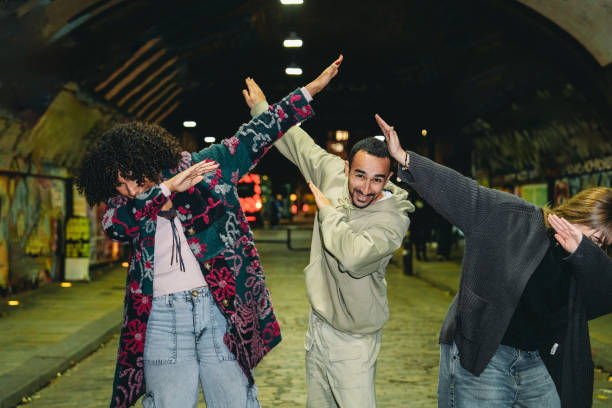 istock Three friends dabbing under a bridge at night 2197440555
