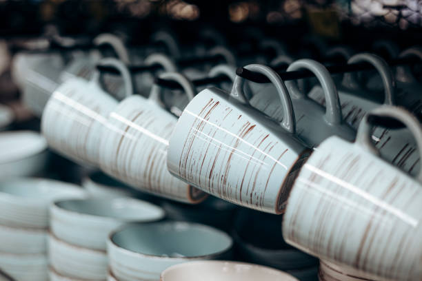 istock Shelf with ceramic cups and plates for sell in a tableware store. 2197441142