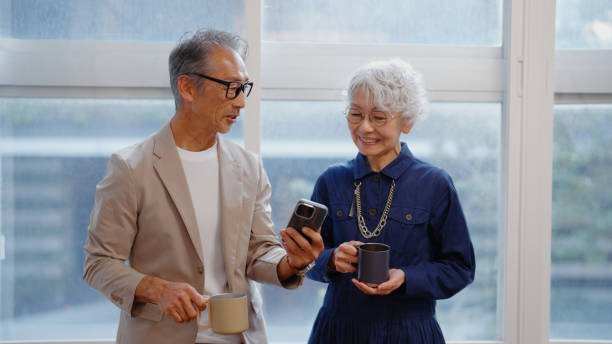 istock Senior Businessman and Businesswoman Networking Over Coffee while Using Smartphone 2197441210