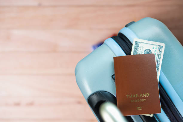 Thai passport with money on suitcase