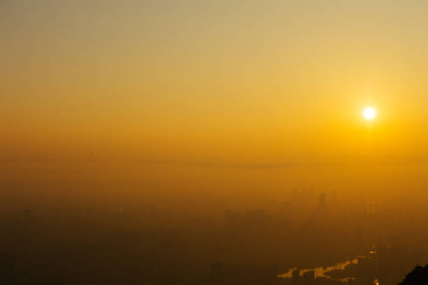 istock A city shrouded in mist under the setting sun 2197445484