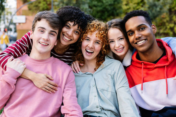 istock College student friends smiling at camera posing for a group portrait at campus. 2197446987
