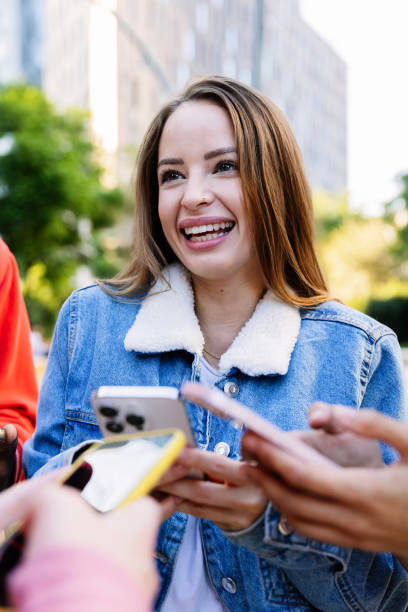 istock Multiracial young people watching funny content on mobile phone app. 2197447263