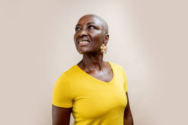 istock Mature woman contemplating at beige background 2197449301