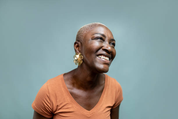 Happy mature woman looking away at blue background