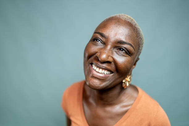 istock Happy mature woman looking away at blue background 2197449357