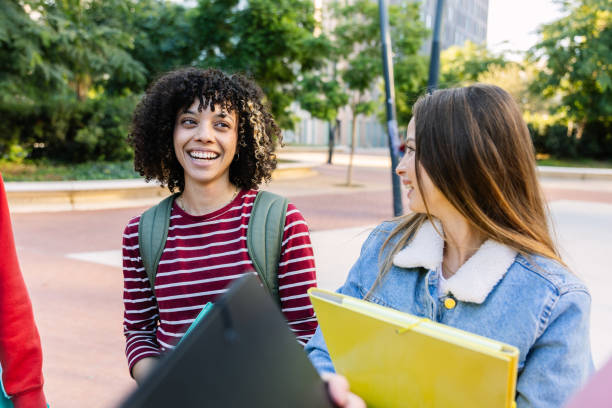 istock Young group of student people hanging out at college campus 2197449428