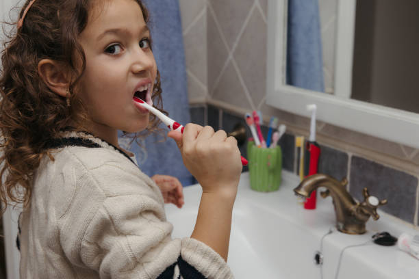 istock Girl brushing her teeth in the bathroom 2197451027