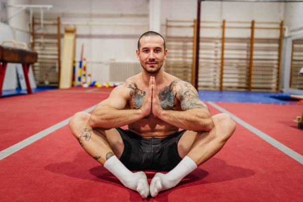 Man doing yoga in the gym