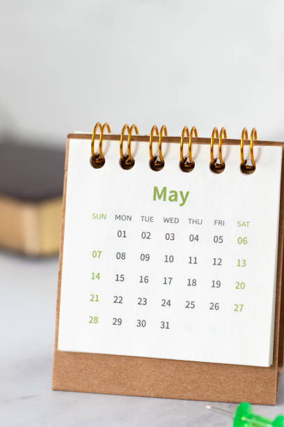 istock May calendar with holy bible book on white marble background 2197452216