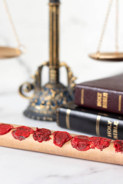 istock Seven seals scroll with holy bible book and ancient balance scale in the background 2197452219