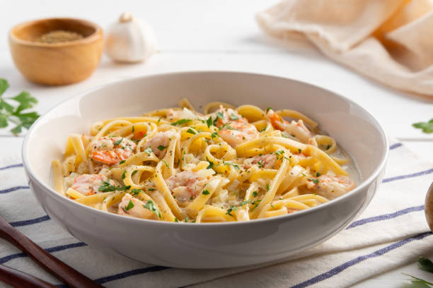 istock Fettuccine pasta with shrimp in white cream sauce. 2197453081
