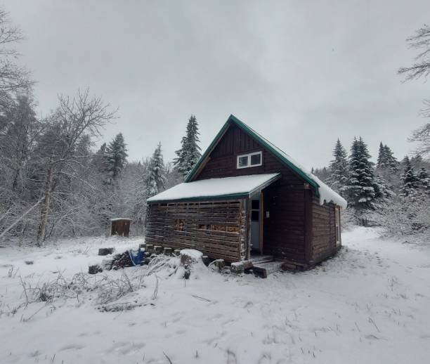 istock Winter cabin in the wood 2197453343