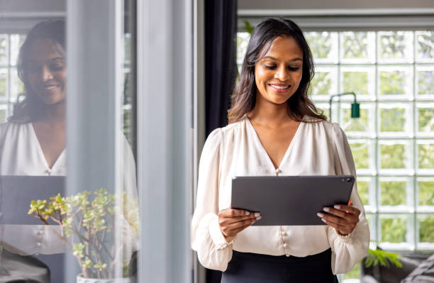 istock Real estate agent using a digital tablet while visiting a house for sale 2197455432
