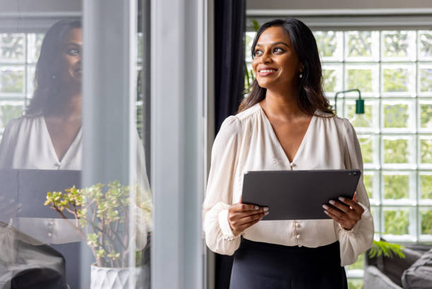 istock Happy real estate agent using a digital tablet and smiling 2197455449