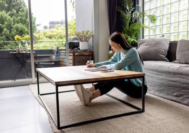 istock Happy woman working at home using her digital tablet 2197455469