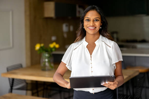 istock Portrait of a happy real estate agent using a digital tablet 2197455494