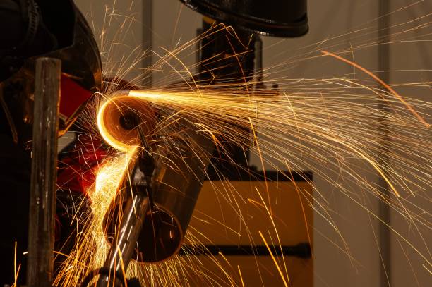 istock A welder wearing a protective mask cuts a metal pipe. 2197456585