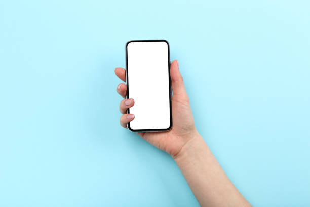 istock Smartphone in female hand on blue background 2197458095